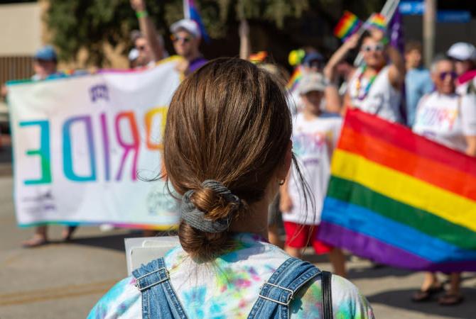 girl watching a gay pride parade